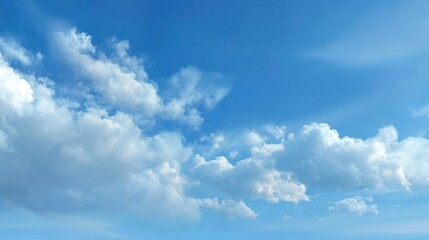 Fototapeta premium A serene blue sky adorned with fluffy white clouds, perfect for depicting tranquility and natural beauty.