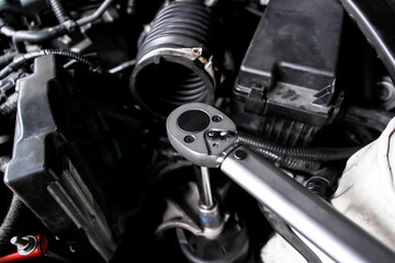 Torque wrench in use, auto repair or car maintenance and engine work with mechanic tool, automotive...