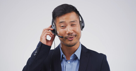 Customer support, talking and face of Asian man in studio for virtual help, contact us and networking. Mockup space, call center and person with headset for consulting service on white background