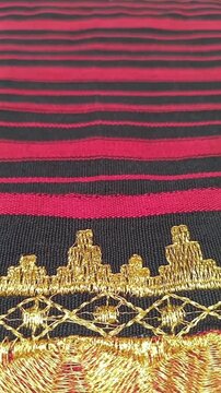 Kain tapis or Lampung tapis fabric with golden threads, geometric motifs, and traditional woven textures.
gold background or ethnic background concept