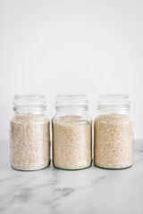 glass jar with white rice of including jasmine basmati and sushi rice, healthy pantry ingredients