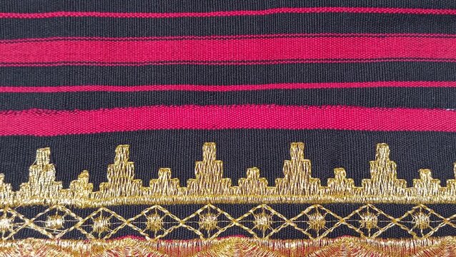 Kain tapis or Lampung tapis fabric with golden threads, geometric motifs, and traditional woven textures.
gold background or ethnic background concept