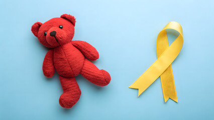 Childhood Cancer Awareness: A plush red teddy bear rests beside a yellow ribbon on a serene blue backdrop, symbolizing hope and support for those battling childhood cancer.