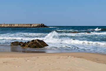 idyllic seascape with beach and jetty