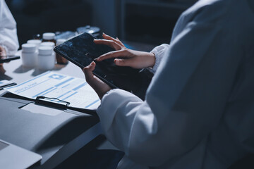 Male and female doctors are having a meeting in a hospital room.