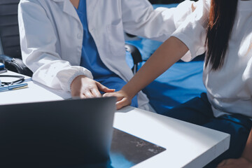 The doctor is checking and encouraging the patient.