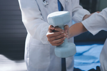 Unrecognizable uses blue hand weight during physical therapy session