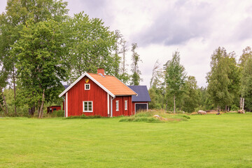 Old red wooden croft in the Swedish countryside