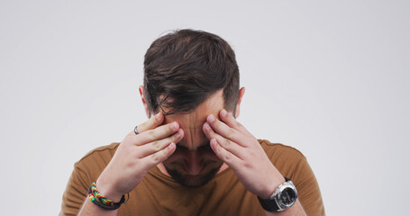Pain, tension and man with headache in studio from stress, hypertension and overwhelmed by ache....