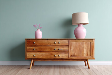 Mid-Century Wooden Sideboard With Pink Vase and Table Lamp Against Teal Wall