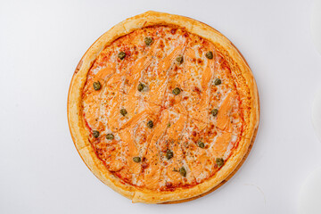 A golden-crusted pizza topped with salmon and capers, ready to be enjoyed