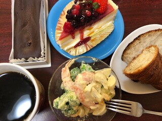 fresh fruit cake and chocolate cake with coffee, bread and salad