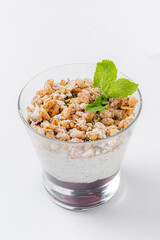 A tasty yogurt parfait with crunchy granola and fresh mint for vibrant textures
