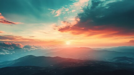 Fototapeta premium A breathtaking sunset over a mountain range with colorful clouds and golden sunlight.