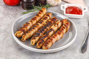 Grilled meat sausages wrapped bacon