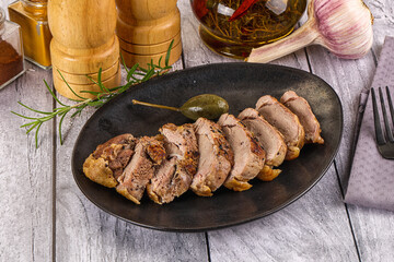 Roasted duck breast slices in the plate