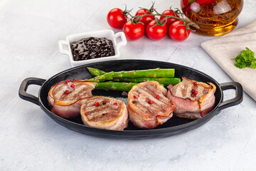 Tasty grilled pork medallion with bacon