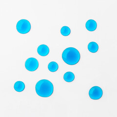 Blue drops of cosmetics on a white background