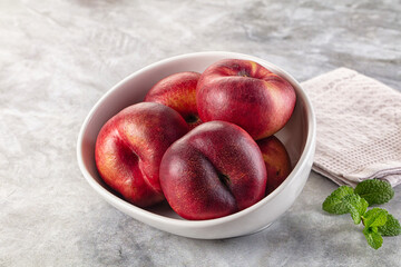 Ripe sweet juicy flat nectarines heap