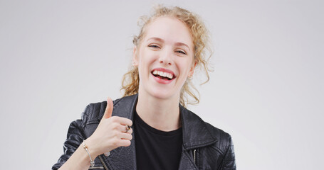 Woman, portrait and smile with thumbs up in studio, motivation or promotion with praise. Agreement,...
