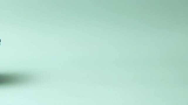 A sleek teal storage container on a soft pastel background.