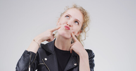 Funny face, pout and thinking with woman in studio for comic, meme and vision. Facial expression,...
