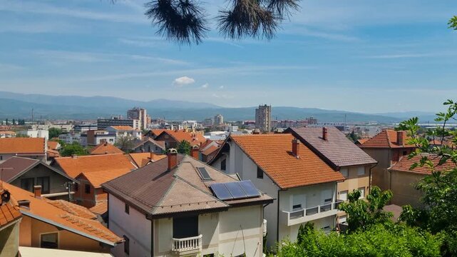 Panoramic view over the rooftops of Leskovac in southern Serbia on a sunny spring day, capturing the charm of everyday life and the simplicity of the local lifestyle under a clear blue sky