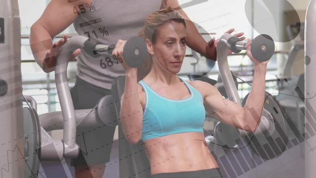 Female client sitting on pec-deck trainer adjusting handles for proper form before chest-fly on cue