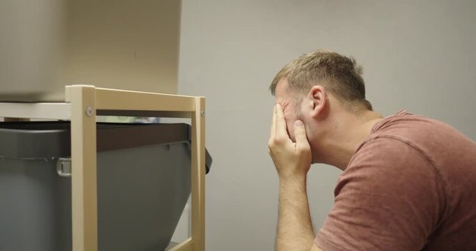 Man Assembling Shelf Without Safety Glasses Gets Something in Eye