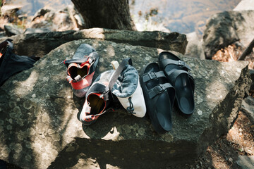 climbing shoes and chalk bag on a rock outside for outdoor climbing