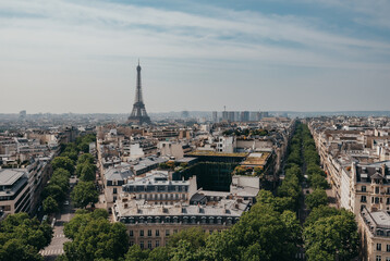 View of Eiffel Tower over rooftops of Paris from Arc de Triomphe.