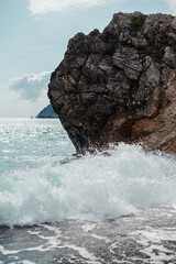 Waves Crashing Against Rocky Cliff by the Sea