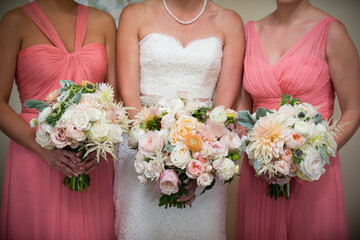 Bride and Bridesmaids Holding Elegant Floral Bouquets