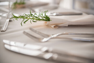 Elegant Wedding Place Setting with Rosemary and Soft Candlelight