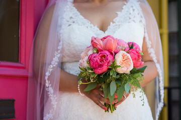 Bride Holding Vibrant Pink and Peach Peony Wedding Bouquet