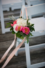 Pink and White Floral Aisle Marker with Ribbon on White Chair