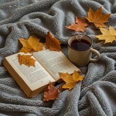 Cozy autumn reading with hot tea and fallen leaves