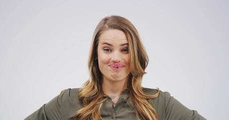 Tongue out, silly and portrait of woman in studio for funny face, humor and comedy on white...
