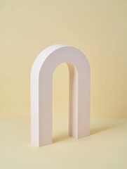 Minimalist archway sculpture on a soft yellow background