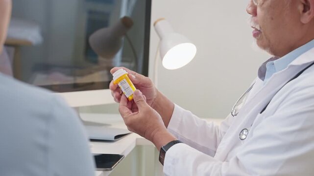 Asian doctor in uniform attentively assists a senior couple with medical paperwork in a hospital area, explaining health records and test results with care and professionalis senior health	