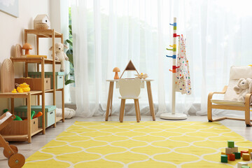 Stylish playroom with toys and furniture. Interior design