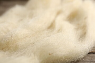 Natural felting wool on wooden background, closeup