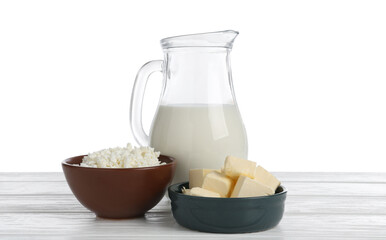 Different dairy products on wooden table against white background