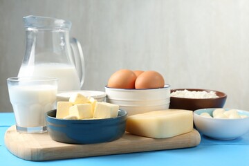 Different dairy products and eggs on light blue wooden table