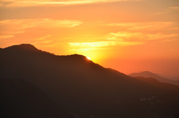 Sunset at night on Rio de Janeiro with city lights and the sea and the mountains