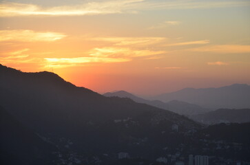 Fototapeta premium Sunset at night on Rio de Janeiro with city lights and the sea and the mountains