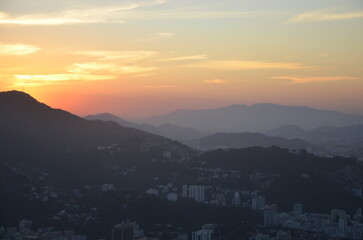 Sunset at night on Rio de Janeiro with city lights and the sea and the mountains