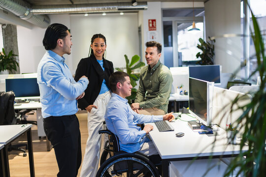 Diverse team working together in an inclusive office environment, demonstrating collaboration and accessibility in the workplace