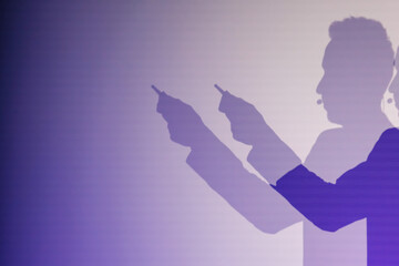 Silhouettes of person on stage holding objects against a purple gradient background embodying focus