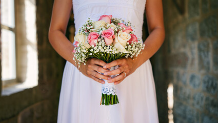 Bride holding wedding bouquet of roses close-up